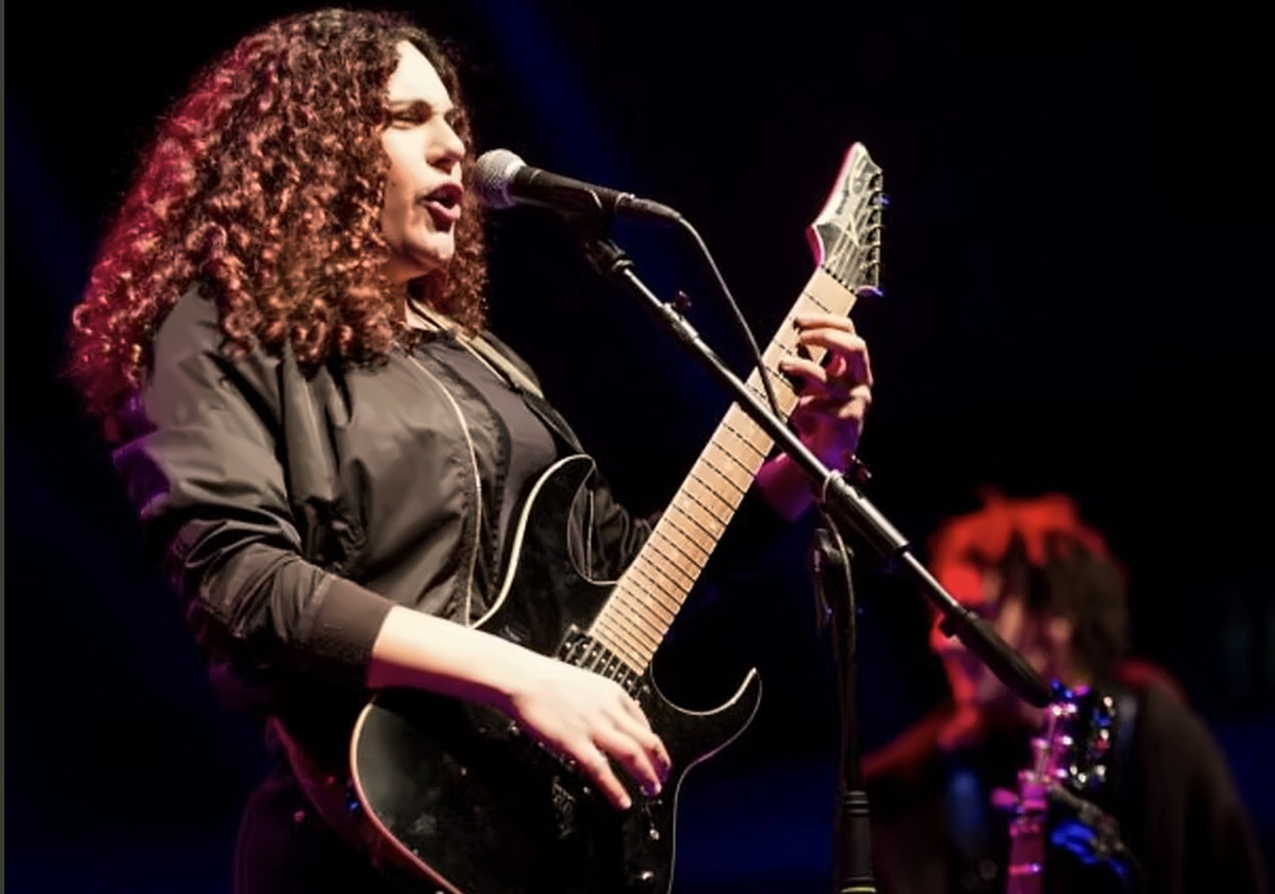 Live on stage with guitar during the residency show